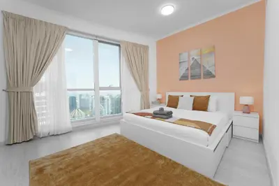 a bedroom with a white bed and a large window at Marco Polo - Your luxurious high-floor escape in Dubai Marina in Dubai