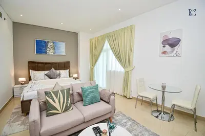 a living room with a couch and a bed at Luxury Escapes - Budget Studio with Balcony, Yacht Bay Marina in Dubai