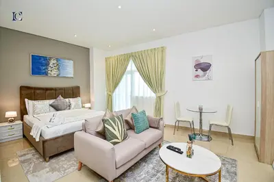 a living room with a couch and a bed at Luxury Escapes - Budget Studio with Balcony, Yacht Bay Marina in Dubai