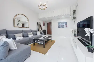 a living room with a couch and a table at Great Gatsby's Home in Dubai