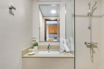 a bathroom with a sink and a mirror at Silkhaus Modern Burj Khalifa View Studio in Dubai