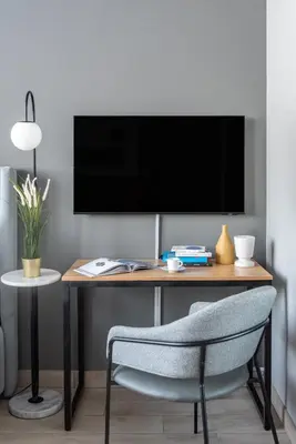 a desk with a tv and a chair in a room at Silkhaus Modern Burj Khalifa View Studio in Dubai