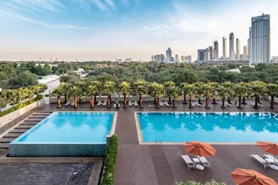 a swimming pool on the roof of a building with a city skyline at Silkhaus Modern Burj Khalifa View Studio in Dubai