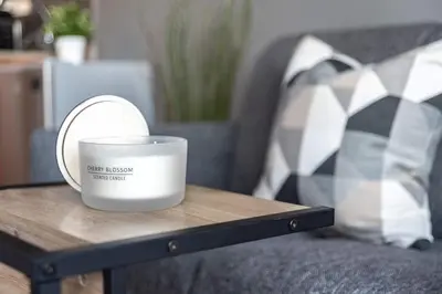 a candle sitting on a coffee table next to a couch at Silkhaus Modern Burj Khalifa View Studio in Dubai