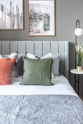 a bedroom with a bed with pillows on it at Silkhaus Modern Burj Khalifa View Studio in Dubai