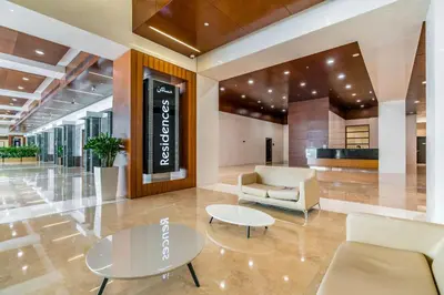 a lobby with a couch and a table and chairs at Silkhaus comfy furnished studio in the heart of DIFC in Dubai