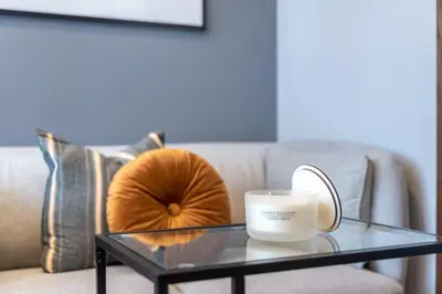 a coffee table with a candle on a couch at Silkhaus comfy furnished studio in the heart of DIFC in Dubai