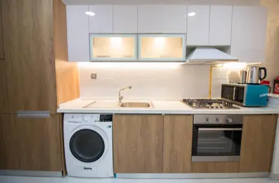 a kitchen with a sink and a washing machine at Fully Furnished Studio, Ready to Move-in! Resortz 19 in Dubai