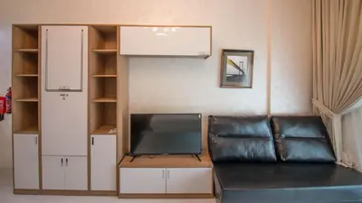 a living room with a couch and a flat screen tv at Fully Furnished Studio, Ready to Move-in! Resortz 19 in Dubai