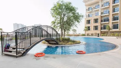 a metal bridge over a pool in a building at Fully Furnished Studio, Ready to Move-in! Resortz 19 in Dubai