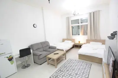 a living room with a couch and a table at Special Offer Studio for Rent in Dubai in Dubai