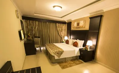 a hotel room with a bed and a window at Ivory Grand Hotel Apartments in Dubai