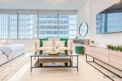 a living room with a bed and a table at Sleek Studio at Sky Gardens DIFC by Deluxe Holiday Homes in Dubai