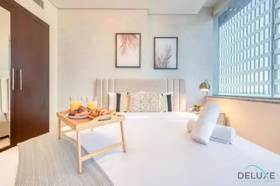 a hotel room with a bed and a table with fruit on it at Sleek Studio at Sky Gardens DIFC by Deluxe Holiday Homes in Dubai