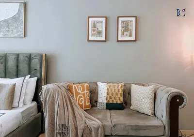 a living room with a couch with pillows on it at Luxury Escapes - Modern Studio near Metro in X1 Tower JLT in Dubai