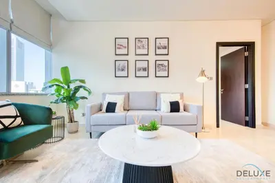 a living room with a couch and a table at Best Deal Elegant Studio with Balcony & Prime Location by Deluxe Holiday Homes in Dubai