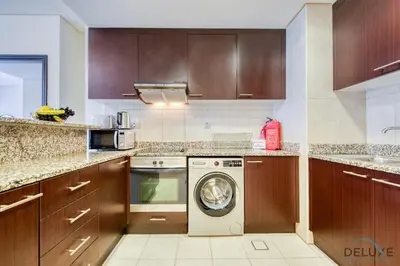 a kitchen with a washer and a dishwasher at Best Deal Elegant Studio with Balcony & Prime Location by Deluxe Holiday Homes in Dubai