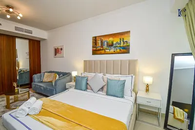 a bedroom with a large bed and a couch at Luxury Escapes - Cozy Studio - Goldcrest Executives JLT in Dubai