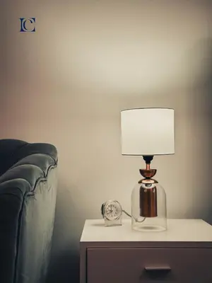a lamp on a table next to a bed at Luxury Escapes - Cozy Studio - Goldcrest Executives JLT in Dubai