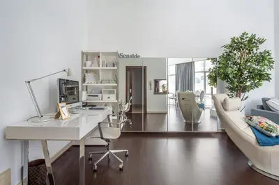 a living room with a desk and a couch at Frank Porter - Marina Promenade in Dubai