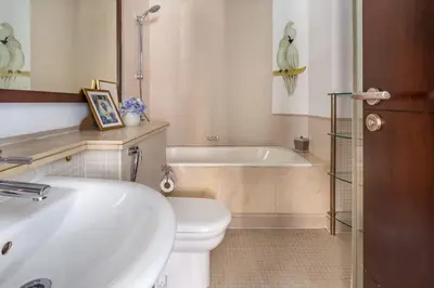 a bathroom with a tub and a toilet and a sink at Frank Porter - Marina Promenade in Dubai