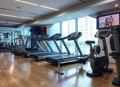 a gym with a bunch of tread machines in a room at Frank Porter - Marina Promenade in Dubai