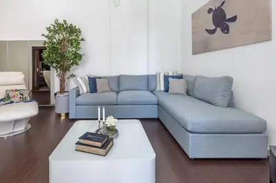 a living room with a blue couch and a coffee table at Frank Porter - Marina Promenade in Dubai