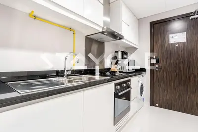 a kitchen with a sink and a stove at Staycae Holiday Homes - Artesia in Dubai