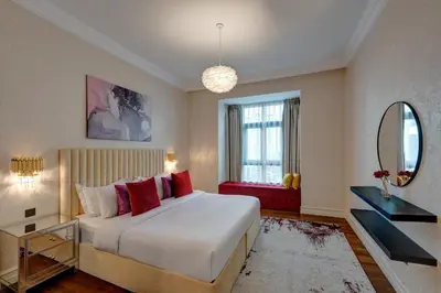 a bedroom with a large bed and a mirror at Durrani Homes - Unique Garden Apt at Souk Al Bahar besides Dubai Mall & Burjkhalifa with private jaccuzi in Dubai