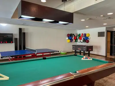 a room with a pool table and ping pong balls at Durrani Homes - Unique Garden Apt at Souk Al Bahar besides Dubai Mall & Burjkhalifa with private jaccuzi in Dubai
