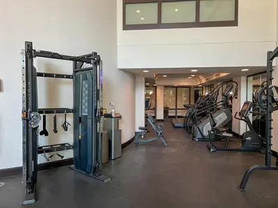 a gym with several treadmills and machines at Durrani Homes - Unique Garden Apt at Souk Al Bahar besides Dubai Mall & Burjkhalifa with private jaccuzi in Dubai