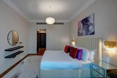 a bedroom with a large white bed and a mirror at Durrani Homes - Unique Garden Apt at Souk Al Bahar besides Dubai Mall & Burjkhalifa with private jaccuzi in Dubai
