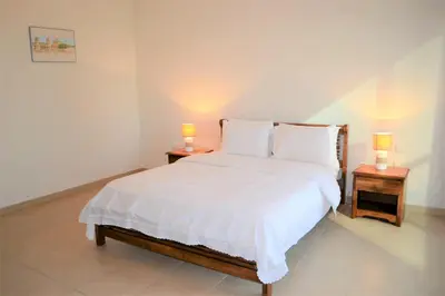 a bedroom with a white bed with two lamps on tables at Luxury Escapes - Large 1Bed with balcony and a great marina view in JBR in Dubai