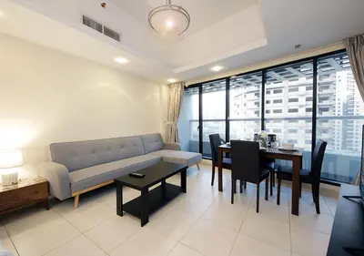 a living room with a couch and a table with chairs at RH- Cozy Studio, Al Waleed , Cluster R, JLT in Dubai