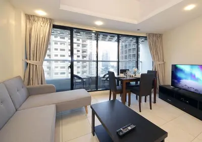 a living room with a couch and a table at RH- Cozy Studio, Al Waleed , Cluster R, JLT in Dubai