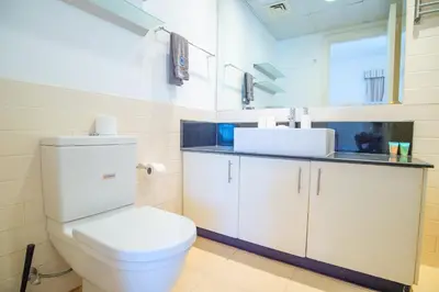a bathroom with a white toilet and a sink at Luxury Escapes - Spacious 2BR Apt in the heart of Dubai Marina- Yacht Bay in Dubai