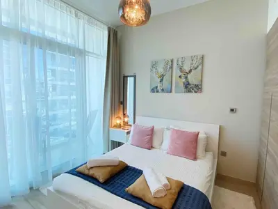 a bedroom with a bed with pink and white pillows at PROMO I Sea view I 1 BR apartment I Studio One Tower I Dubai Marina in Dubai
