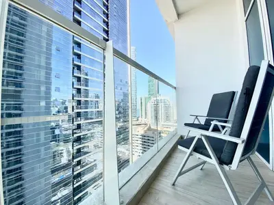 a chair on a balcony with a view of a city at PROMO I Sea view I 1 BR apartment I Studio One Tower I Dubai Marina in Dubai