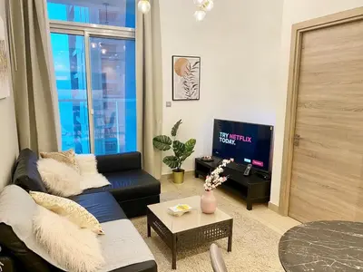 a living room with a couch and a tv at PROMO I Sea view I 1 BR apartment I Studio One Tower I Dubai Marina in Dubai