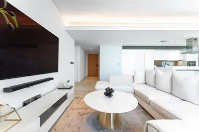 a living room with a white couch and a table at Most beautiful 3 BR apt in BLUEWATERS ISLAND, DUBAI in Dubai