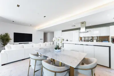 a kitchen and dining room with a marble table and chairs at Most beautiful 3 BR apt in BLUEWATERS ISLAND, DUBAI in Dubai