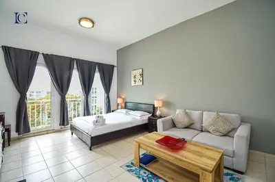 a living room with a bed and a couch at Luxury Escapes - Tranquil Studio Near Furjan Metro - Relaxing Holiday Retreat in Dubai