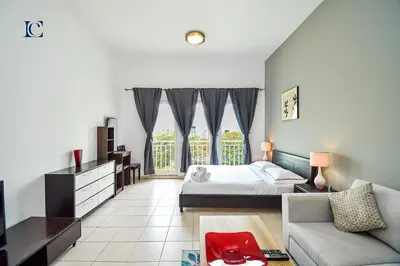 a living room with a bed and a couch at Luxury Escapes - Tranquil Studio Near Furjan Metro - Relaxing Holiday Retreat in Dubai
