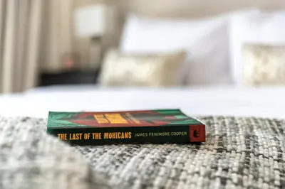 a book sitting on top of a bed at The Smart Concierge - Address JBR in Dubai