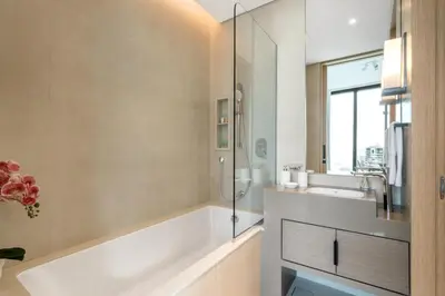 a bathroom with a tub and a sink and a mirror at The Smart Concierge - Address JBR in Dubai