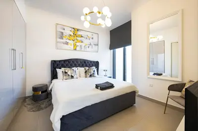 a bedroom with a large bed with a black headboard at Modern Dubai Hills Luxury 4 BEDROOM VILLA in Dubai