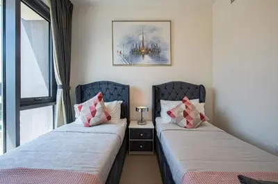 two beds sitting next to each other in a room at Modern Dubai Hills Luxury 4 BEDROOM VILLA in Dubai
