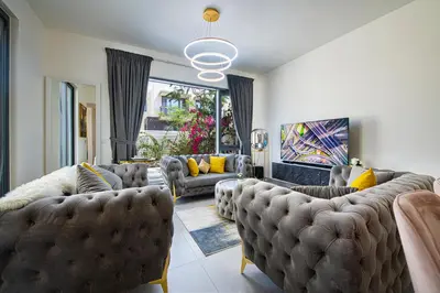 a living room with couches and yellow pillows at Modern Dubai Hills Luxury 4 BEDROOM VILLA in Dubai