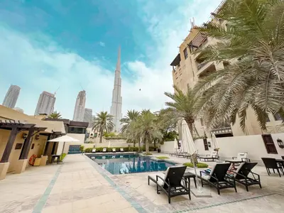 a view of the burj khalifa from a hotel courtyard at Trophy 2BR Aladdin Estate w Burj Khalifa View in Dubai