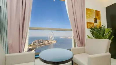 a room with a window with a view of the ocean at Regent Sea View 2BR Apartment JBR Beach Walk - next to Bluewater Island & Dubai Eye in Dubai